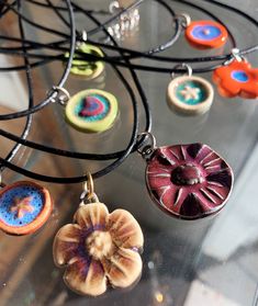 several necklaces with different designs on them