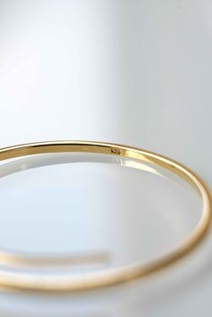 **GOLD BANGLE WILL BE RESTOCKED BY JUNE23, please add yourself to the waiting list and you'll receive an automated email notification as soon as it is restocked. Modern and minimal yet classic and elegant. Our Crossover Bangle is an investment piece and will always have a place in your collection of jewelry. The bangle comes in one size 2.6 inches diameter and can be adjusted to the size of your wrist. Handmade with utmost care with the finest sterling silver and plated with the highest quality Gold Hoop Bangle In Minimalist Style, Minimalist Gold Hoop Bangle, Minimalist Gold Hoop Bracelet, Adjustable Minimalist Gold Bracelet With Polished Finish, Classic Bangle Bracelet With Simple Design, Classic Hoop Cuff Bracelet Gift, Classic Hoop Cuff Bracelet As Gift, Minimalist 14k Gold Hoop Bangle, Minimalist Yellow Gold Hoop Bracelet