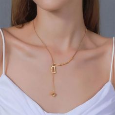 Material Gold Plated Elegant Gold-tone Plated Charm Necklace, Elegant Metal Initial Pendant Necklace, Modern Gold Necklaces For Anniversary, Modern Gold Lariat Necklace, Modern Gold Metal Lariat Necklace, Yellow Gold Initial Pendant Necklaces, Elegant Heart Shaped Gold Chain Necklace, Elegant Heart-shaped Gold Chain Necklace, Elegant Gold Metal Initial Necklace