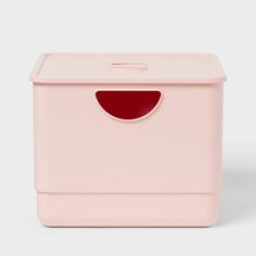 a pink storage box with a hole in the middle and red lining on the lid