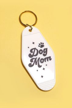 a keychain with the words dog mom printed on it and a paw print