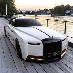 a white car parked on top of a wooden pier