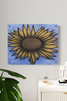 a painting of a sunflower on a white wall