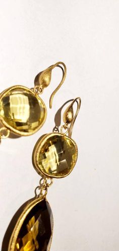 These vintage earrings are quite stunning and just what you need for special occasions. They feature faceted round and teardrop shaped smoky and yellow quartz in gold settings that catch the light just perfectly. They dangle from gold-toned ear wires. From the top of the wire to the bottom of the pearl, they measure 3 inches. These earrings are in very good vintage condition. Thanks for visiting my vintage jewelry store! Back to my shop here: https://www.etsy.com/shop/RemembrancesofYours Elegant Gold Teardrop Earrings With Gemstone, Gold Teardrop Gemstone Earrings For Wedding, Gold Teardrop Earrings With Gemstone For Anniversary, Gold Teardrop Gemstone Earrings, Gold Gemstone Teardrop Earrings For Formal Occasions, Gold Briolette Earrings Nickel Free, Vintage Gold Gemstone Earrings, Gold Faceted Drop Earrings, Gold Citrine Drop Jewelry