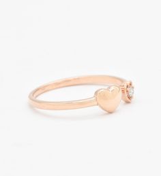 Certified Real Diamond Open Heart Ring set with Diamond, size 2 millimeters diameter, 0.03 Carats.Solid 14k Rose Gold ☞ made to last.Click here for ☞ Solid Gold CollectionDiamond Details:• CERTIFIED Natural Diamond• Weight: 0.03 Carats• Dimensions: 2mmSolid Gold Details:• 1.2 grams of 14k Solid Rose Gold• Dimensions: Band width ≈ 1.5mm, thickness ≈ 1mm• Lasts a lifetime - Perfect for everyday use (won’t tarnish)! *Final weight & dimensions depending on the chosen ring sizeSKU RT-1543 14k Rose Gold Stackable Promise Rings, Promise Ring In Rose Gold With Single Diamond, Rose Gold Promise Ring With Single Diamond, Valentine's Day Rose Gold Stackable Rings, Valentine's Day Single Diamond Ring In Fine Jewelry Style, 14k Gold Heart Ring With Single Diamond For Gift, Rose Gold Stackable Heart Ring For Wedding, Rose Gold Birthstone Ring With Single Diamond For Promise, Anniversary Rose Gold Birthstone Ring With Single Diamond