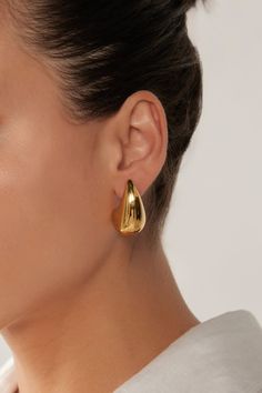 STYLE DETAILS: Indulge in the opulent Halcyon Earring. With its oversized teardrop shape in stainless steel or gold plating, this earring exudes sophistication and elegance. A timeless design that will transcend seasons, it will become a piece you'll reach for again and again, no matter the occasion. FEATURES: Drop design Stud closure Gold Plated, Stainless Steel 3cm length Linen Bottoms, Unique Fits, Drop Design, Again And Again, Drops Design, Mid Length Dresses, Skirt Leggings, Gold Style, Dresses With Leggings