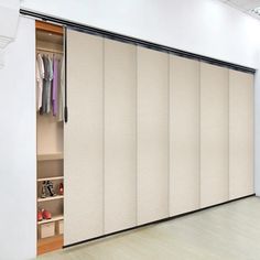 an open closet with sliding doors and shoes