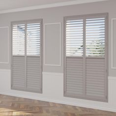 an empty room with white shutters and wood floors