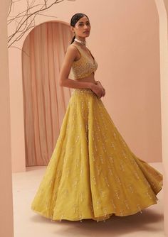 Editors Note Elevate your elegance with this stunning yellow lehenga set adorned with cascading pearls and glistening glass beads. The intricate detailing and exquisite craftsmanship make it a perfect choice for weddings and grand celebrations, ensuring you shine with timeless beauty and grace. Yellow Cutdana Sets For Reception, Elegant Yellow Dola Silk Anarkali Set, Elegant Yellow Palazzo Set With Traditional Drape, Yellow Palazzo Set With Intricate Embroidery For Diwali, Yellow Cutdana Sharara For Reception, Yellow Embroidered Palazzo Set For Diwali, Yellow Embellished Designer Wear Sets, Elegant Yellow Palazzo Set With Resham Embroidery, Yellow Palazzo Set With Dupatta For Reception