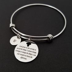 "Serenity Prayer Bracelet Personalized Initial Bangle Bracelet! A round charm printed with Serenity Prayer beginning with \"Lord grant me the serenity\" on a stainless steel expandable bangle bracelet makes the perfect gift for you or a loved one. God, grant me the serenity to accept the things I cannot change, Courage to change the things I can, And wisdom to know the difference. The religious bracelet charm is made from stainless steel and measures 24 mm by 24 mm. The bible verse bracelet is h Inspirational Round Bracelets As Gift, Adjustable Hypoallergenic Round Name Bracelet, Adjustable Hypoallergenic Name Bracelet, Inspirational Round Adjustable Jewelry, Inspirational Adjustable Round Jewelry, Meaningful Adjustable Charm Bracelet, Meaningful Adjustable Bangle Bracelet, Adjustable Round Jubilee Stretch Bracelet, Adjustable Round Bracelet As Best Friend Gift