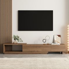 a living room with a large flat screen tv mounted on the wall above it's entertainment center