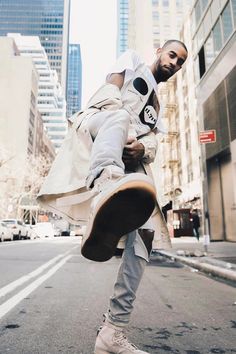 a man is doing a trick on his skateboard in the middle of the street