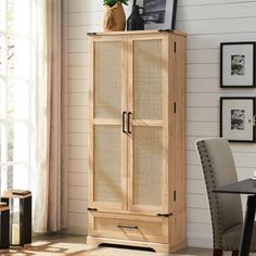 a tall wooden cabinet sitting next to a window