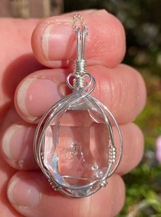 A rare and unique enhydro Herkimer Diamond quartz crystal, artfully wire wrapped in sterling silver. This beautiful pendant features a natural, 15x24 mm, sparkling clear Herkimer Diamond quartz crystal we mined in Middleville NY. The crystal has great form and clarity, a couple tiny baby rider crystals, a small inclusion, a small extra face, and a water cavity with a small bubble that does not move. See all photos and video and look for the small bubble in the center of the crystal. Looks even b Silver Wire Wrapped Crystal Jewelry, Wire Wrapped Silver Crystal Jewelry, Silver Wire-wrapped Crystal Jewelry, Silver Herkimer Diamond Jewelry As Gift, Silver Teardrop Wire Wrapped Crystal Necklace, Silver Teardrop Wire Wrapped Crystal Necklaces, Silver Teardrop Crystal Necklace Wire Wrapped, Clear Mineral Crystal Jewelry For Gifts, Handmade Silver Crystal Pendant