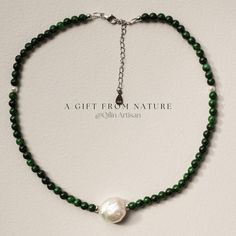 *Handcrafted: Each piece is meticulously handmade, ensuring a personal touch in every necklace. *Natural Stones and Pearls: Features vibrant Gan Qing jade beads paired with a large, luminous white pearl at the center. The Gan Qing jade, known for its rich green hue, adds a luxurious touch, while the white pearl brings an unmatched elegance to the design. *Size: Designed with precision, it features a length suitable for various occasions, ensuring both prominence and comfort. *Designer Piece: Exclusively designed by me, showcasing a harmonious blend of creativity and traditional craftsmanship. | Key Highlights of the "Green Waves" Necklace | *Unique Craftsmanship: The dedication to crafting each necklace is evident through the careful selection of uniform Gan Qing jade beads, ensuring a coh Jade Necklaces With Round Beads For Gifts, Jade Bead Necklace For Gifts, Jade Necklace With Round Beads For Gifts, Jade Crystal Necklace With Polished Beads For Gift, Jade Pearl Necklace With Gemstone Beads As Gift, Green Pearl Necklace For Gift, Spiritual Jade Beaded Necklace As A Gift, Jade Gemstone Beaded Necklace For Gift, Jade Gemstone Beaded Necklace As Gift