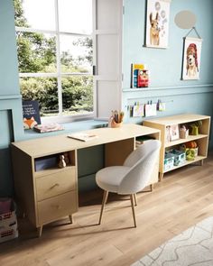 a child's room with blue walls and wooden furniture, including a chair and desk