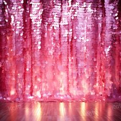 pink sequin curtain with light shining through it