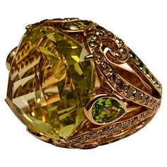 This statement Cocktail Ring centering a large cushion shaped vivid yellowish green lemon citrine. Surrounded by Champagne colored glittering diamonds and Tsavorite garnets, all fancifully set in 18 K Rosegold. The ring is currently size 54/14 but can be resized larger or smaller if necessary. Luxury Multi-stone Yellow Gemstones, Luxury Yellow Multi-stone Gemstones, Luxury Yellow Gold Peridot Jewelry, Luxury Peridot Rings With Accent Stones, Luxury Citrine Gemstones With Accents, Formal Green Citrine Jewelry, Luxury Multi-stone Peridot Ring, Luxury Peridot Multi-stone Rings, Luxury Peridot Jewelry For Gifts