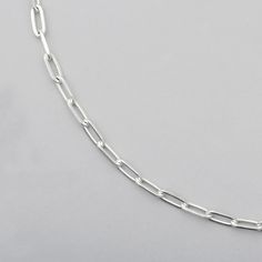 close up of sterling silver chain with diamond cut  paperclip links Sterling Silver Paperclip Bracelet With Solid Link, Sterling Silver Paperclip Bracelet With Solid Link Construction, Modern Silver Necklace With Rectangular Links, Classic Silver Cable Chain Bracelet, White Gold Cable Chain Bracelet With Rectangular Links, Sterling Silver Delicate Chain Necklace Paperclip Shape, Sterling Silver Delicate Paperclip Chain Necklace, Silver Oval Link Box Chain Necklace, Everyday Chain Bracelet With Rectangular Links