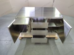 a metal table with drawers on each side