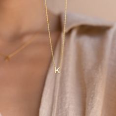 Our Initial Necklace is the best option for those who want a meaningful piece while also remaining subtle. The custom pendant and chain are dainty enough to layer with other necklaces, yet it is still noticeable when worn alone.• Material: High Quality Solid 925 Sterling Silver• Finish: 18K Gold• Featuring ~ 6mm Initial Charm on an adjustable 16 to 18 inch chain. Model is wearing the 17 inch length in the first listing image SKU: RR-NR085 K Necklace, Dainty Initial Necklace, Ring Der O, Initial Pendant Necklace, Custom Pendants, Rose Gold Pendant, Waterproof Jewelry, Trendy Necklaces, Letter Pendants