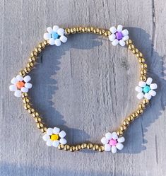 Flower Beaded Bracelet - multi color with 3mm 18k gold filled beads ✨✨ Bracelet comes as shown, if you would like another color please add in Personalization Section* CARING TIPS FOR YOUR JEWELRY ⭐️Treat and store with care. ⭐️ For longevity, avoid exposing your jewelry to water. ⭐️ Avoid having direct contact with lotions, perfumes, sanitizers as these chemicals may cause discoloration of your jewelry. Beaded Bracelet Flower, Flower Seed Bead, Flower Beaded Bracelet, Beaded Flower Bracelet, Super Bowl Outfit, Mama Bracelet, Bracelet Rainbow, Bracelet Flower, Seed Bead Bracelet