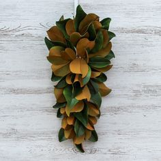 a green and yellow wreath hanging on a white wall