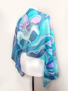 Hand painted scarf with Pegasus made of natural silk, in purple - blue - turquoise color set. This fantasy designer scarf is made to order. The Pegasus is a magical creature, a winged horse symbolizing wisdom and fame and more recently poets' inspiration (so imagine what a lovely gift the scarf would made for your poet friend). The Pegasus scarf depicts the winged horse flying with two peacocks on a starry, cloudy night sky. It is composed with tones of cool blue and turquoise, soft pastel mint Blue Hand Painted Bohemian Silk Scarf, Blue Bohemian Hand Painted Silk Scarf, Bohemian Blue Hand Painted Silk Scarf, Artistic Handmade Blue Silk Scarf, Bohemian Blue Silk Scarf Gift, Bohemian Blue Silk Scarf As Gift, Bohemian Blue Silk Scarf For Gift, Blue Shawl Scarf For Gift, Artsy Blue Scarf As A Gift