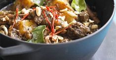 a blue pot filled with food on top of a table