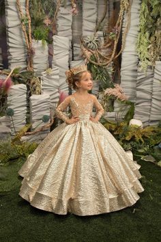 Elevate your little princess's special occasion ensemble with The Yana Girls Pageant Gown in Taffeta & Brocade. This stunning gown features a sheer bodice with long sleeves, adorned with a breathtaking design of floral crystal beaded lace embroidery. The full pageant wedding flower girls gown is truly spectacular, with a gorgeous brocade skirt that boasts a hint of a train for added drama. A beautiful bow that creates the perfect finishing touch on this magnificent ball gown. Get ready to turn h Gold Flower Girl Dress, Gold Flower Girl, Girls Gold Dress, Girls Pageant Gowns, Pink Flower Girl Dresses, Princess Flower Girl Dresses, Kids Gown, Bow Belt, Dress Birthday