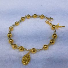 This bracelet has designed by Korean sister for her mother. Her mother lost his husband 2 months ago so daughter want to give some special gift as a Catholic. 24k gold 6mm ball has weaved by 18k solid gold wire. Crucifix and miraculous medal are 999% gold purity of 24k gold. For the safety reason, I am using 18k gold clasp,18k gold chain. Express tracking parcel will be used for delivery. If customer want lower cost and no taxes, please use my local webstore. * Material : 24K Solid gold & 18 Adjustable Gold Rosary Bracelet With Charms, Spiritual Yellow Gold Charm Bracelet, Spiritual Gold Bracelet With Round Beads, Spiritual Yellow Gold Bracelet, Elegant 8mm Beads Jewelry For Blessing, Elegant Gold Rosary As Gift, Elegant Gold Rosary For Gift, Spiritual Gold Beaded Bracelets With Charms, Handmade Gold Charm Bracelet With Round Beads