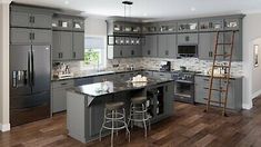 a large kitchen with gray cabinets and stainless steel appliances