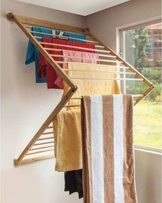 a rack with towels hanging from it in front of a window