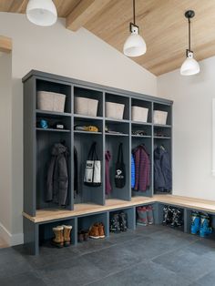 a room filled with lots of coats and shoes on top of shelves next to lamps