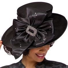 Introducing the exquisite Giovanna HG1103-BLK Church Hat, a stylish accessory designed to add an air of elegance and sophistication to your special occasion wear. This beautiful hat is crafted with careful attention to detail, ensuring that you look nothing short of stunning when attending any event requiring a touch of class. The hat is presented in a classic black color, imbued with a lustrous sheen that radiates style. Its design features a prominent bow, artfully crafted to draw the eye and First Lady Church Suits, Church Dresses For Women, Church Suits And Hats, Women Church Suits, Women Church, Black Church, Church Hat, Church Suits, Elegant Hats