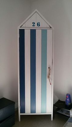 there is a blue and white striped cabinet in the room