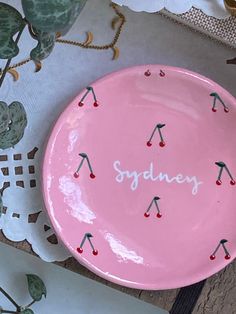 a pink plate with the word sydney written on it