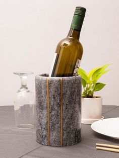 a bottle of wine sitting in a marble container