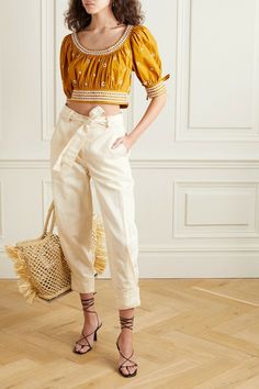 Ulla Johnson translates her serious case of wanderlust into beautiful garments that are designed to wear on holiday. Cut from cotton and linen-blend twill in an ivory hue, these tapered pants sit on the natural waist and are detailed with buttons at the cuffs. Match your top to the contrast stitching.                                           Levi belted cotton and linen-blend twill tapered pants .Ulla Johnson Levi Pant in Neutral 66% cotton 34% linen. Made in India. Dry clean only. Zip fly with Spring High-waisted Pants With Belt Detail, Spring Trousers With Belt Detail, High Waist Pants With Belt Detail For Summer, Chic Cotton Bottoms With Belt Detail, Summer Workwear Pants With Belt Detail, Chic Spring Pants With Belt Detail, Summer Workwear Bottoms With Belt Detail, Straight Leg Pants With Belt Detail For Spring, Cropped Cotton Bottoms With Belt Loops