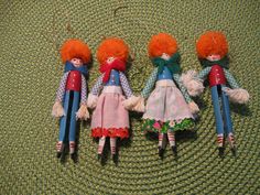 three little dolls are laying on the floor