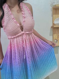 a woman in a pink and blue crochet dress