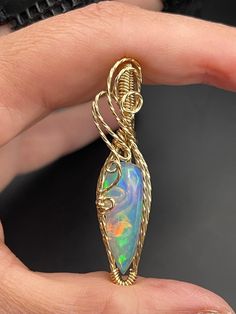 This beautiful Ethiopian Opal gold filled pendant is about 1 1/4 inches tall and 1/2" wide, it includes a 18" gold filled necklace and in a gift box, ready for gifting! These are not costume pieces that will chip away or rust over time. They will last forever if taken care of, which is why I include a free polishing cloth with every order.  All of my pieces are made with high quality wire from Rio Grande. Quality is very important to me! Message me, If you have any questions, I'm happy to help. Wire Wrapped Yellow Gold Pendant Jewelry, Yellow Gold Wire Wrapped Pendant Jewelry, Gold Teardrop Hand Wrapped Jewelry, Gold Wire Wrapped Jewelry For Anniversary, 14k Gold Wire Wrapped Necklace For Gift, 14k Gold Wire Wrapped Necklace As Gift, Artisan Gold Jewelry With Birthstone, Elegant Hand Wrapped Pendant Jewelry, Opal Round Pendant Jewelry For Gifts