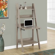 a wooden ladder desk with a laptop on it