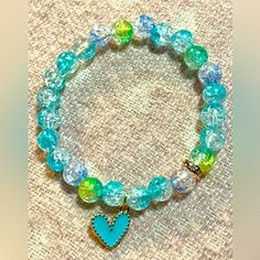 This Listing Is For One “Teal And Yellow Crackle Beaded Heartbracelet” -Made With 8mm Acrylic Crackle Color Beads, A 6mm Rose Gold Crystal Rhinestone Spacer Bead And Teal Heart Charm Strung On A Clear Elastic Stretch Cord. -Light In Weight, Smooth Surface And Exquisite In Appearance, Not Easy To Fade Or Break And Durable Enough To Wear Daily - I Highly Recommend Measuring Your Wrist With String & Choose A Size 1/4”-1/2” Larger Than Your Wrist Depending On How Snug You Want Your Bracelet To Fit. Turquoise Heart-shaped Beaded Bracelet, Blue Heart-shaped Jewelry With Colorful Beads, Blue Beaded Bracelets With Heart Beads, Turquoise Heart-shaped Beaded Bracelets, Blue Beaded Heart Bracelet, Blue Heart-shaped Beaded Bracelets, Blue Heart-shaped Beaded Bracelet, Turquoise Bracelets With Heart Beads For Jewelry Making, Blue Heart Beaded Bracelet With Round Beads