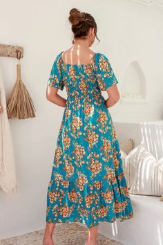 A fun floral maxi dress with a gorgeous teal color to make the look pop. This dress has short sleeves with an elastic neckline, allowing you to style the dress on or off the shoulders. There are two elastic lines below the chest for shaping. The rest of the dress is loose, flowy, and ready for a lunch date with friends. Model is 5'10" and wearing her true size Small. Small: Bust 14", Length 52" 100% Rayon Turquoise Floral Print Maxi Dress, Bohemian Midi Dress With Smocked Bodice And Short Sleeves, Turquoise Short Sleeve Maxi Dress For Summer, Casual Turquoise Floral Print Maxi Dress, Casual Turquoise Maxi Dress With Floral Print, Spring Maxi Dress With Elastic Neckline And Short Sleeves, Spring Maxi Dress With Short Sleeves And Elastic Neckline, Beach Maxi Dress With Smocked Bodice And Short Sleeves, Green Maxi Dress With Smocked Bodice And Short Sleeves