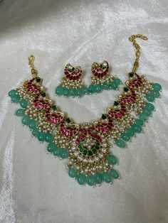 Indian Ethnic Jadau Ahemdabadi Kundan 22 Carat Gold Plated Sea Green Necklace Set * This Set Is made up with High Quality Pachi Kundan * 22 Carat Gold Plating Is used * High Quality Beads Are used * Set includes Necklace,Earrings  * Droppings color can be changed according to your requirement We made Jewelry in pachi kundan /Ahemdabadi kundan and made designs on order only , need atleast 25 days to make ,to do customization as they are acceptable. jewellery details :All jewellery are made with silver base and luxury gold plated next to real,generally we work on direct made on order.   We are  the dealers of Authentic and traditional Indian Jewelry  We  are honored to present you our elegant, stylish and unique designs with a  wide range of items in different Indian Jewelry category. Here i Eid Round Kundan Temple Necklace, Ceremonial Kundan Necklace With Stone Work For Eid, Traditional Round Necklaces For Eid, Handmade Kundan Necklace For Ceremonial Occasions, Handmade Kundan Chandbali Temple Necklace, Ceremonial Kundan Necklace Hand Set In Temple Jewelry Style, Ceremonial Kundan Necklace In Temple Jewelry Style, Handmade Chandbali Kundan Bridal Necklace, Hand Set Kundan Necklace For Celebrations