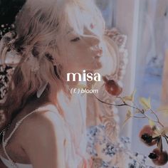 a woman standing next to a window with flowers in her hand and the words misa on it