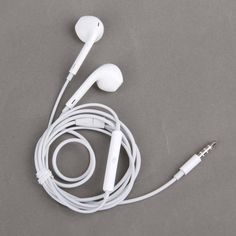 an earphone is laying on the floor next to headphones with wires in it