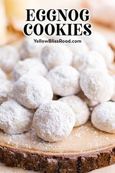 eggnog cookies sitting on top of a cutting board with powdered sugar around them