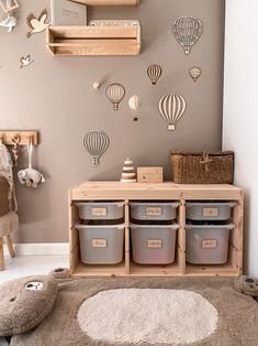 a child's playroom with toys and storage bins on the wall above